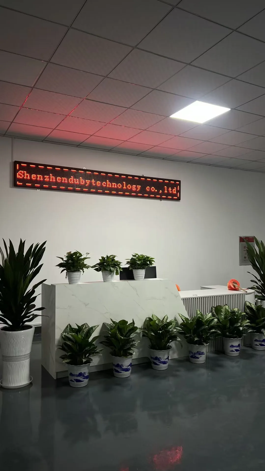 Front Desk - Office reception and company sign for buyer reference during supplier communication. Front Desk for DubyTech automotive electronics supplier